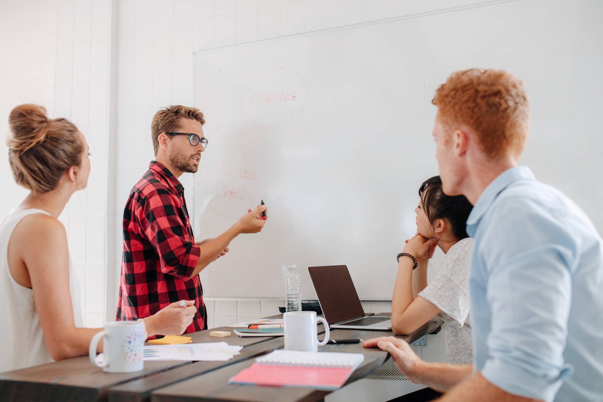 Executive explaining business plans to his coworkers